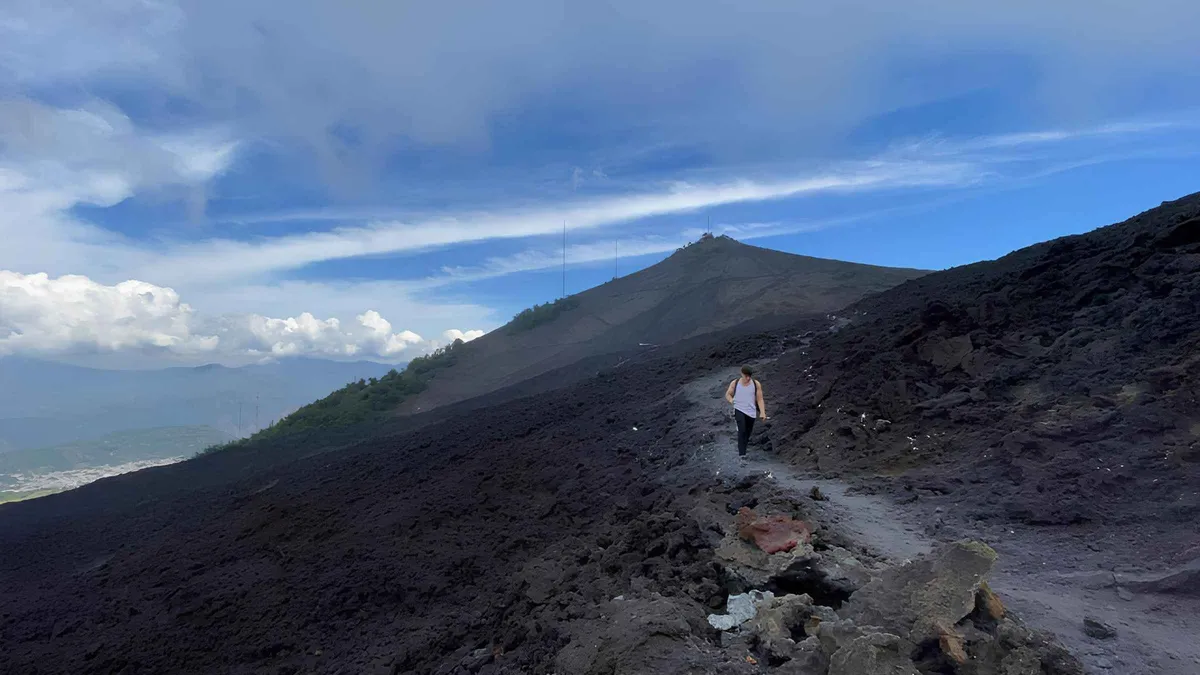 Guided group walking on the dry lava field of Pacaya volcano with steam vents, Pacaya volcano tour from Antigua Guatemala