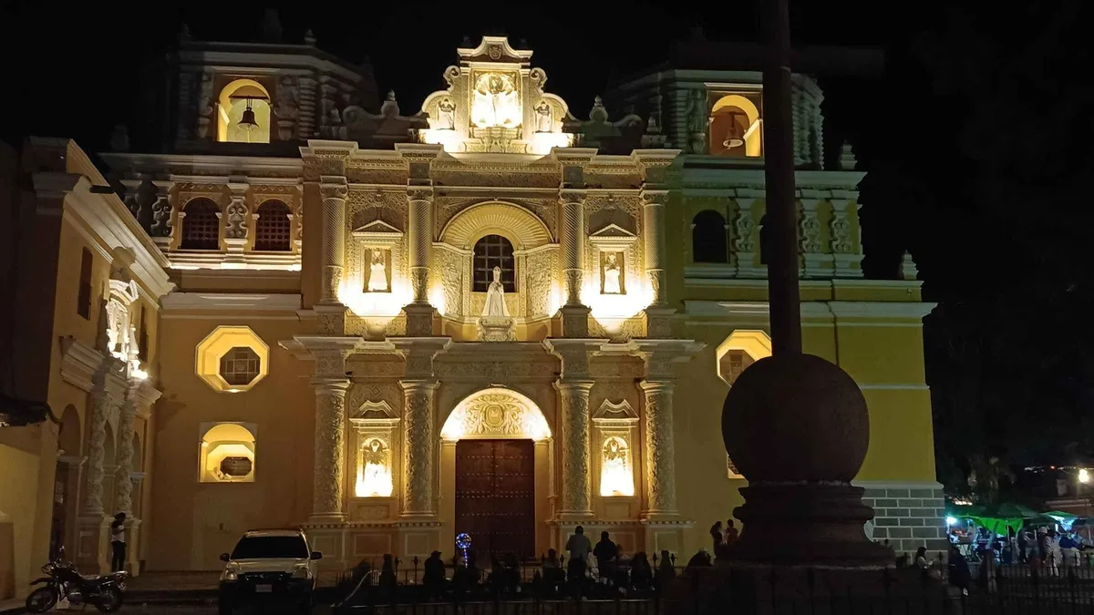 Night walking tour with lanterns outside a ruined church in Antigua Guatemala